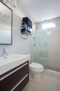 a bathroom with a sink and a toilet and a shower at Freshly Renovated 2 Bedroom Apt 1 Block to King in Charleston