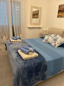 a bedroom with two beds with towels on them at Aqualife luxury apartment in Arzachena