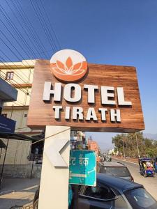 a sign for a hotel trial on a street at HOTEL TIRATH in Rishīkesh