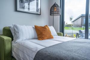 A bed or beds in a room at Cefni Lodge