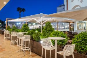 a row of tables and chairs in a restaurant at night at ALEGRIA Florida Park in Santa Susanna