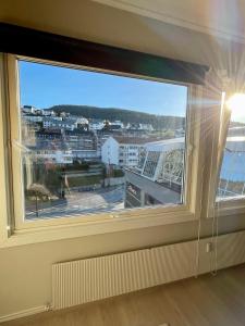 a window with a view of a city at Modern apartment ONLY 5 minutes from City Centre in Bergen