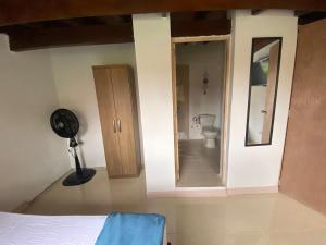 a bedroom with a bathroom with a toilet and a mirror at APARTAHOTEL ESTADIO GOLD in Medellín +93 photos