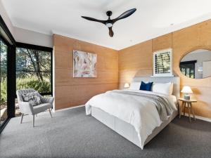 a bedroom with a large bed and a ceiling fan at Abundance in Margaret River Town