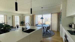 a kitchen with a sink and a table in a room at ApartmentInCopenhagen Apartment 1566 in Copenhagen