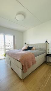 a bedroom with a large bed in a white room at ApartmentInCopenhagen Apartment 1566 in Copenhagen