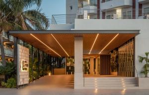 an external view of a building with a wooden walkway at ALEGRIA Florida Park in Santa Susanna +37 photos