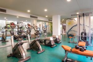 a gym with several treadmills and exercise bikes at ALEGRIA Florida Park in Santa Susanna