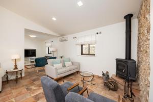 a living room with a couch and a stove at Casa do Carmo in Moncarapacho