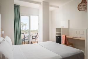 a bedroom with a bed and a table with chairs at ALEGRIA Florida Park in Santa Susanna