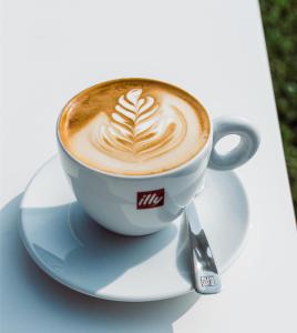 a cup of coffee on a plate on a table at Penzion jako víno in Bulhary