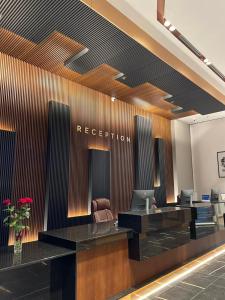 an office lobby with a reception desk and chairs at Hotel & Casino Cherno More in Varna City