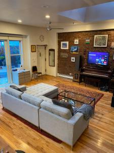 a living room with two couches and a piano at Carriage House Williamsburg Brooklyn NYC in Brooklyn