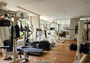 a gym with several treadmills and other equipment at Thermas Paradise Residence in Rio Quente