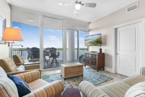 a living room with a couch and a tv at Bel Sole 1102 Spacious water view beach access in Gulf Shores