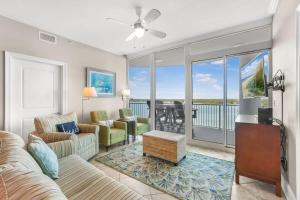 a living room with a couch and a table at Bel Sole 1102 Spacious water view beach access in Gulf Shores