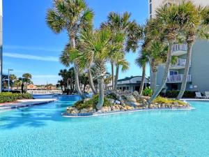 uma piscina com palmeiras num resort em Long Beach Resort Tower II 305 em Panama City Beach