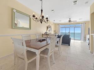 a dining room and living room with a table and chairs at Seagrove Dunes #1 in Seagrove Beach