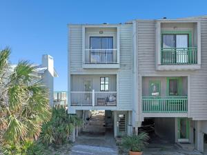 an apartment building with balconies and palm trees at Seagrove Dunes #1 in Seagrove Beach