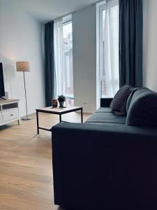a living room with a couch and a table at Apartment Artic I - im Stadtzentrum in Nordhorn