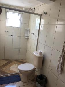a bathroom with a toilet and a shower at Pousadaa São João 144 in Aparecida