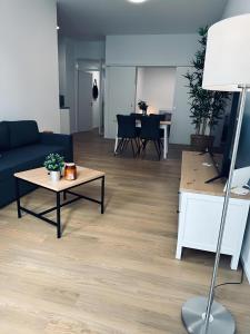 a living room with a couch and a table at Apartment ARTIC I Cityblick & Komfort in Nordhorn +17 photos
