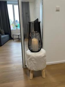 a black bird cage sitting on top of a chair at Apartment Artic III - im Stadtzentrum in Nordhorn