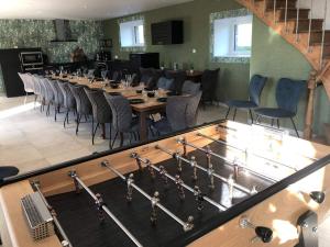 a large dining room with a long table and chairs at Maison des Bruyères 25pers jacuzzi, billard baby in Le Bény-Bocage