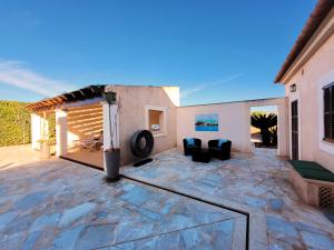 a patio with a stone floor and a house at New, Premium Finca mit Starlight-Pool! South-East Coast in S'Horta