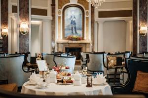 a dining room with a table with a plate of food at Hotel Atlantic Hamburg, Autograph Collection in Hamburg