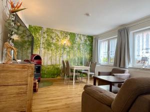 a living room with a wall mural of trees at Spreewaldapartments-Kossatz in Lübben