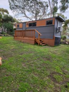 a mobile home with a porch and a deck at Green heavan in Greenvale