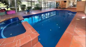 a large swimming pool with blue water in a house at Green heavan in Greenvale