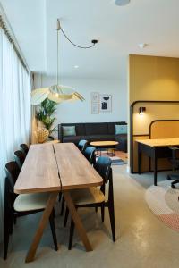 a dining room with a wooden table and chairs at Cityden BoLo District in Amsterdam