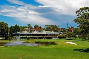 a resort with a pond in front of a building at Aircabin - North Ryde - Sydney - 4 Beds House in Sydney