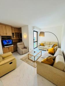 a living room with two couches and a tv at Luxurious Monaco Flat: Stunning Views & Amenities in Monte Carlo