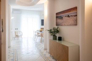 a hallway with a living room and a table at Casa Patty Sorrento in Sorrento