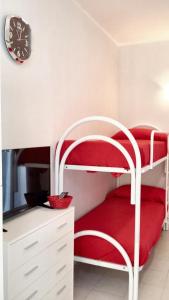 a bedroom with a white bunk bed and a clock at Studio with shared pool terrace and wifi at Sciacca in Sciacca