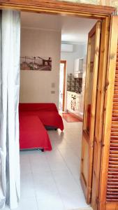a bedroom with two red beds in a room at Studio with shared pool terrace and wifi at Sciacca in Sciacca