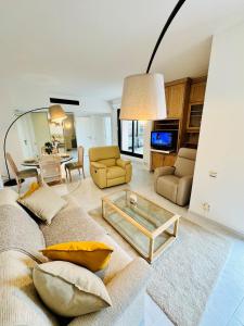 a living room with a couch and a table at Luxurious Monaco Flat: Stunning Views & Amenities in Monte Carlo