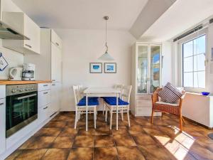 una cucina con tavolo e sedie in una stanza di Moin a Greetsiel