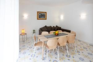 a living room with a table and chairs at Casa Patty Sorrento in Sorrento