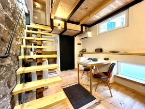 a tiny house with a staircase and a desk at Balloon Boutique House, City Centre in Plovdiv