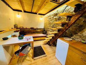 a kitchen with a stone wall and a table and chairs at Balloon Boutique House, City Centre in Plovdiv
