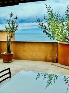 a patio with a table and a view of the ocean at Luxurious Monaco Flat: Stunning Views & Amenities in Monte Carlo