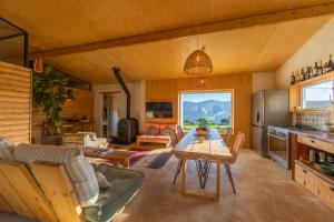 a living room with a table and a kitchen at Casa CORTIJO con piscina privada in Tarifa