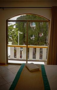 Una ventana grande en una habitación con cama y vistas al mar en Hotel Manzana Blanca 5th Avenue, en Playa del Carmen