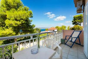 a balcony with a table and chairs on a balcony at Αngelika studios in Argostoli