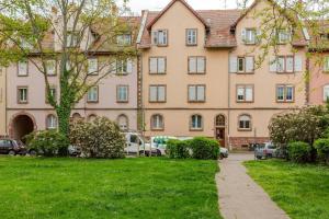 a large building with cars parked in front of it at MAMRAY in Colmar