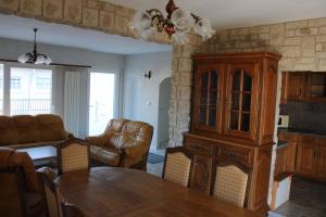 a living room with a dining table and a cabinet at Le gite de la Forêt in Herbsheim